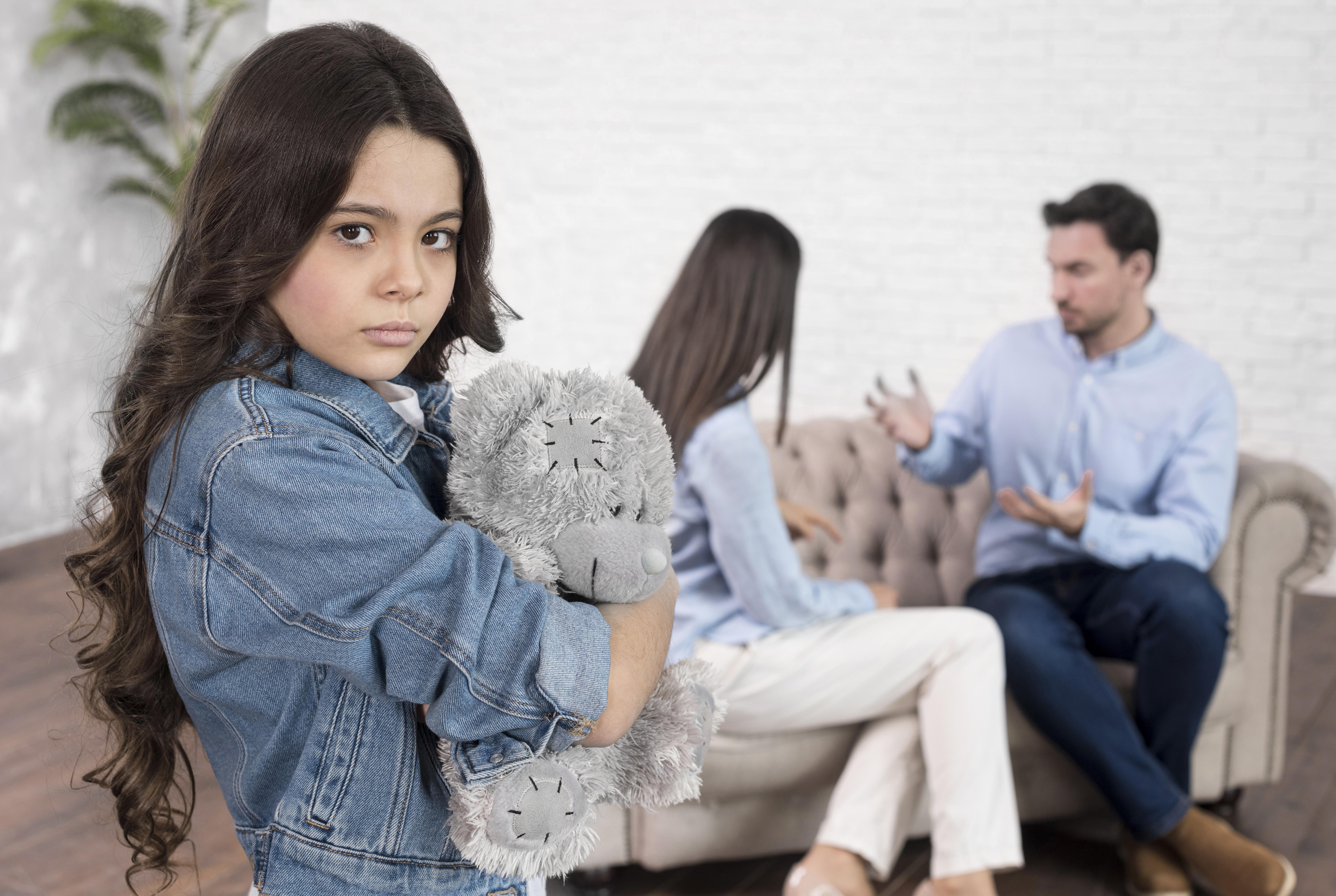 sad girl holding teddy bear